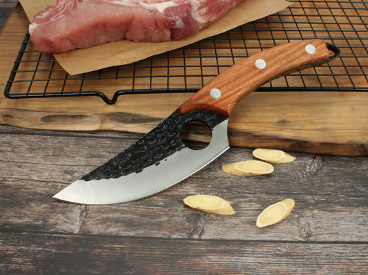 Hand-forged small kitchen boning knife with a sharp high-carbon steel blade and ergonomic handle.
